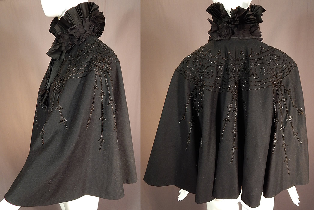 Victorian Black Wool Jet Beaded Pleated Silk High Neck Collar Winter Cloak Cape
This beautiful black beaded winter cloak cape has a dramatic high neck boa pleated stand up collar, silk ribbon bow trim hanging down the front, with hook closures and is fully lined. 