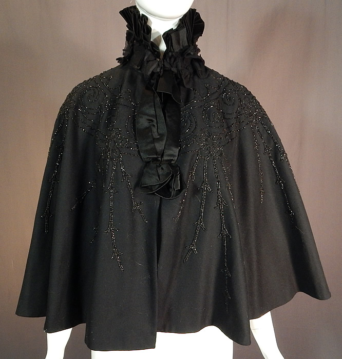 Victorian Black Wool Jet Beaded Pleated Silk High Neck Collar Winter Cloak Cape
The cape measures 21 inches long, 19 inches across the shoulders and has a 15 inch neck. 