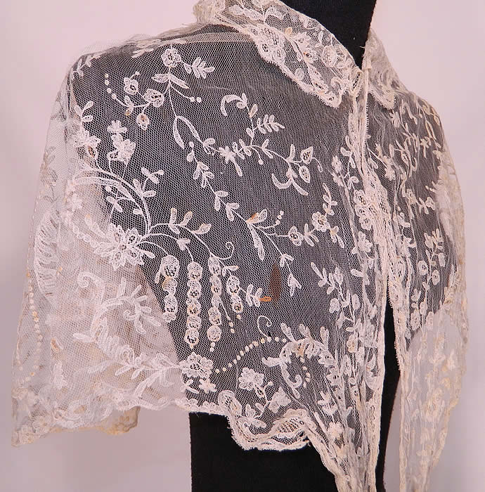 Antique Blonde Lace Tambour Embroidery Fichu Pelerine Collar Cape Shawl. This lovely lace fichu pelerine collar cape short shawl has a small collar, long lappet front ends which could be crossed at the front, tied in the back and would have been worn for modesty. The cape measures 53 inches in circumference at the top, 76 inches along the bottom and is 15 inches wide.