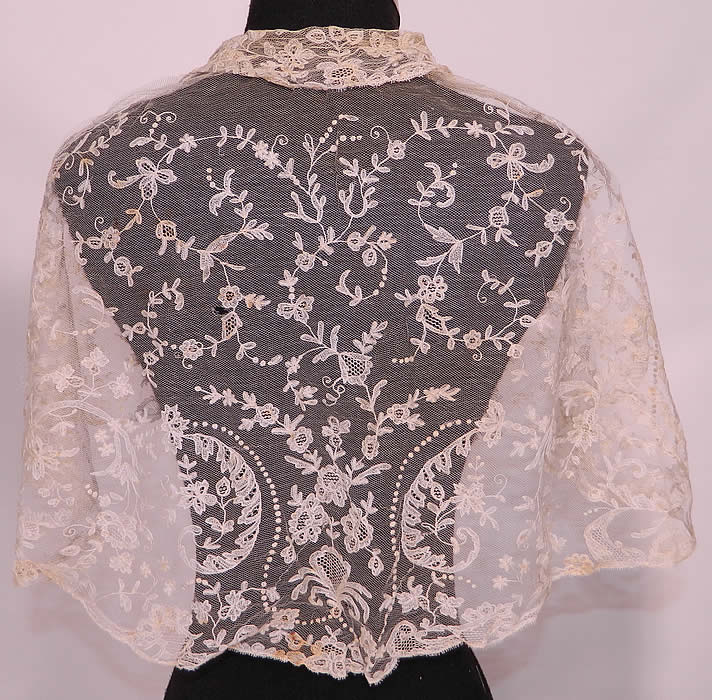 Antique Blonde Lace Tambour Embroidery Fichu Pelerine Collar Cape Shawl. This lovely lace fichu pelerine collar cape short shawl has a small collar, long lappet front ends which could be crossed at the front, tied in the back and would have been worn for modesty. The cape measures 53 inches in circumference at the top, 76 inches along the bottom and is 15 inches wide.