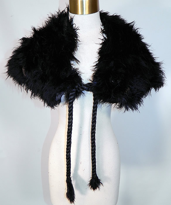 Edwardian Black Ostrich Feather Collar Cloak Cape Stole Shawl Silk Rope Ties. This Edwardian era antique black ostrich feather collar cloak cape stole shawl silk rope ties date from 1910. It is made of soft fluffy black ostrich feathers, backed in a black silk lining, with black silk rope cord ties hanging down from each side with feather trim tassel ends.