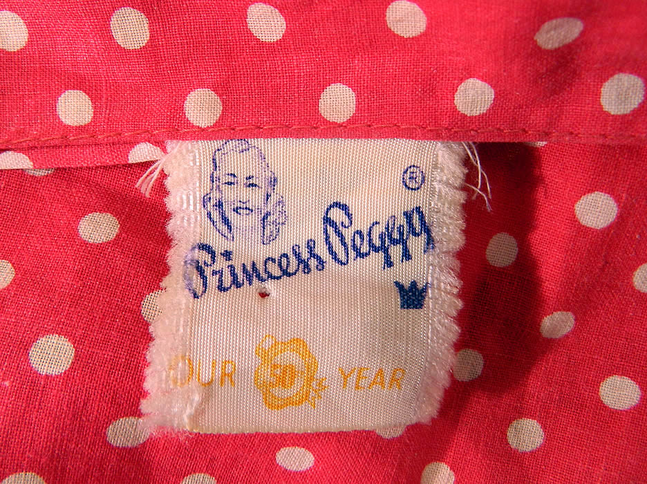 Vintage Princess Peggy Red & White Polka Dot Print Cotton Circle Skirt Halter Dress. There is a "Princess Peggy Our 50 Year" label size 10 tag sewn inside. The dress measures 51 inches long, with a 24 inch waist and 34 inch bust. It is in good condition. This is truly a wonderful piece of wearable art.