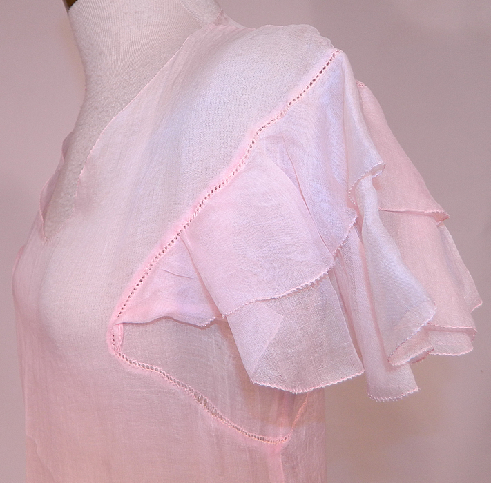Vintage Pink Pastel Pink Organdy White Embroidered Star Applique Party Dress
This pretty pink party dress is a long mid length with a full ruffle skirt, decorative scalloped front waistband, low scoop front neckline, layered ruffle short flirty cap sleeves and is sheer, unlined. 