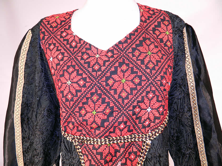 Vintage Al-Karnak Jordan Bedouin Kaftan Jalabiya Thobe Embroidered Maxi Dress
There is a gold metallic lamé and rope trim edging. This beautiful bedouin kaftan maxi dress is a long floor length, loose fitting with a belted tie back, long kimono style sleeves with exaggerated points along the bottom and is unlined. 