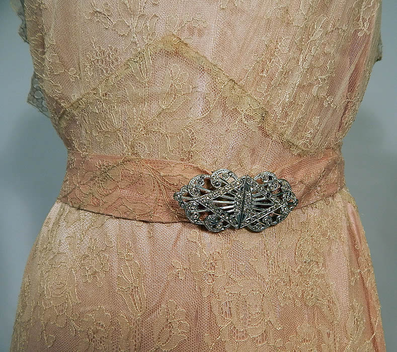 Vintage Cream Chantilly Lace Belted Bias Cut Dress Wedding Gown & Pink Silk Slip
This beautiful bias cut dress has a long floor length full skirt, high lace neckline yoke, short cap sleeves, plunging V back with lace shawl flounce collar, matching lace fabric belt with silver rhinestone buckle clasp closure and is sheer, unlined. 