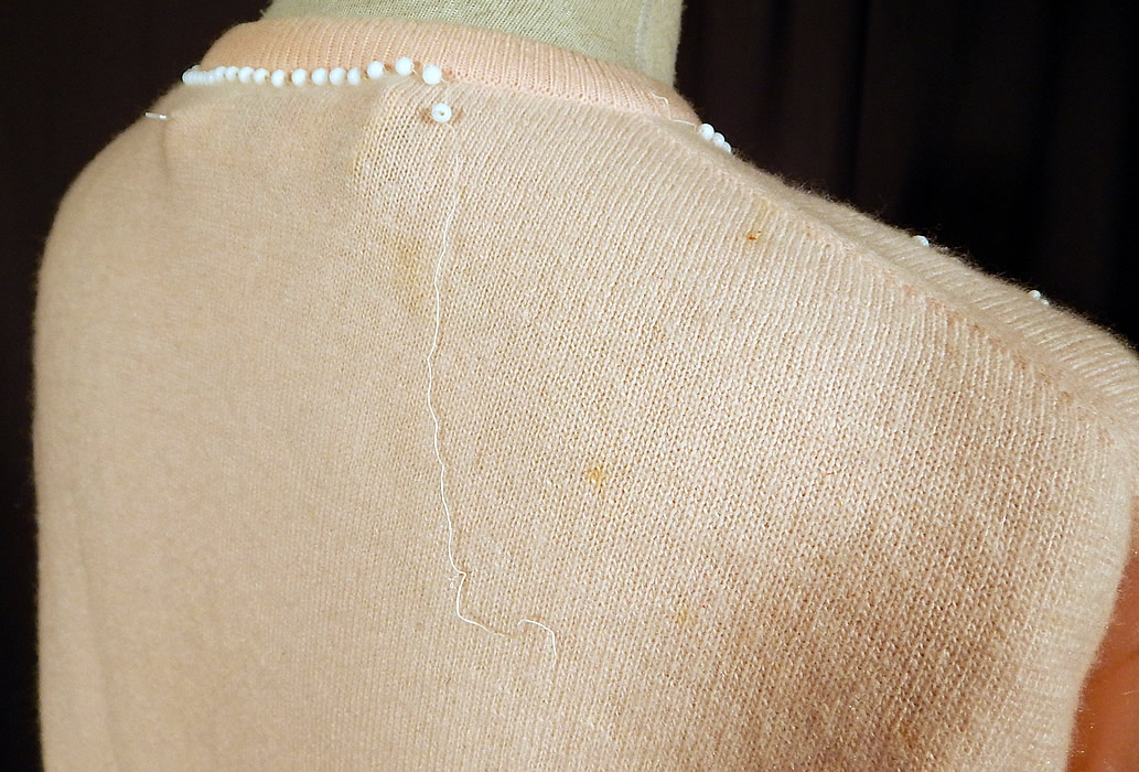 Vintage Pringle of Scotland Pink Cashmere White Beaded Cardigan Sweater
It is in good condition, but has not been cleaned with a few faint small stains and some loose missing beading on the neckline (see close-up). This is truly a wonderful piece of hand beaded wearable art!