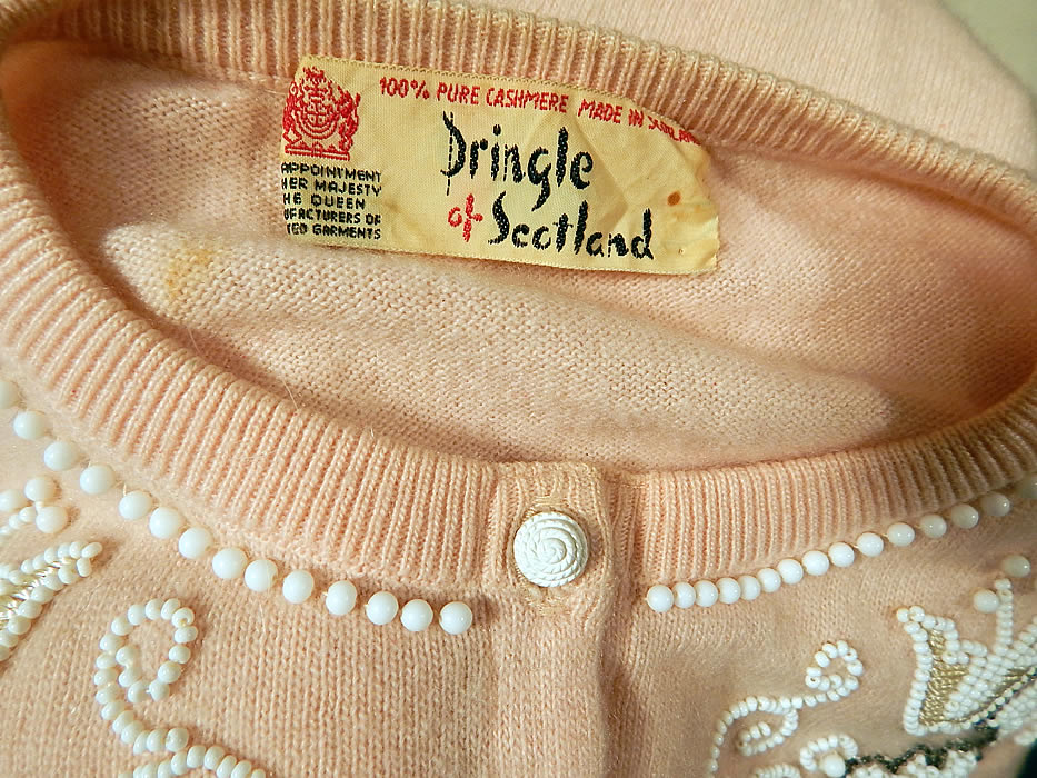 Vintage Pringle of Scotland Pink Cashmere White Beaded Cardigan Sweater
The sweater measures 20 inches long, with a 24 inch waist, 38 inch bust and 19 inch long sleeves. There is a "Pringle of Scotland Made in Scotland" label sewn inside.
