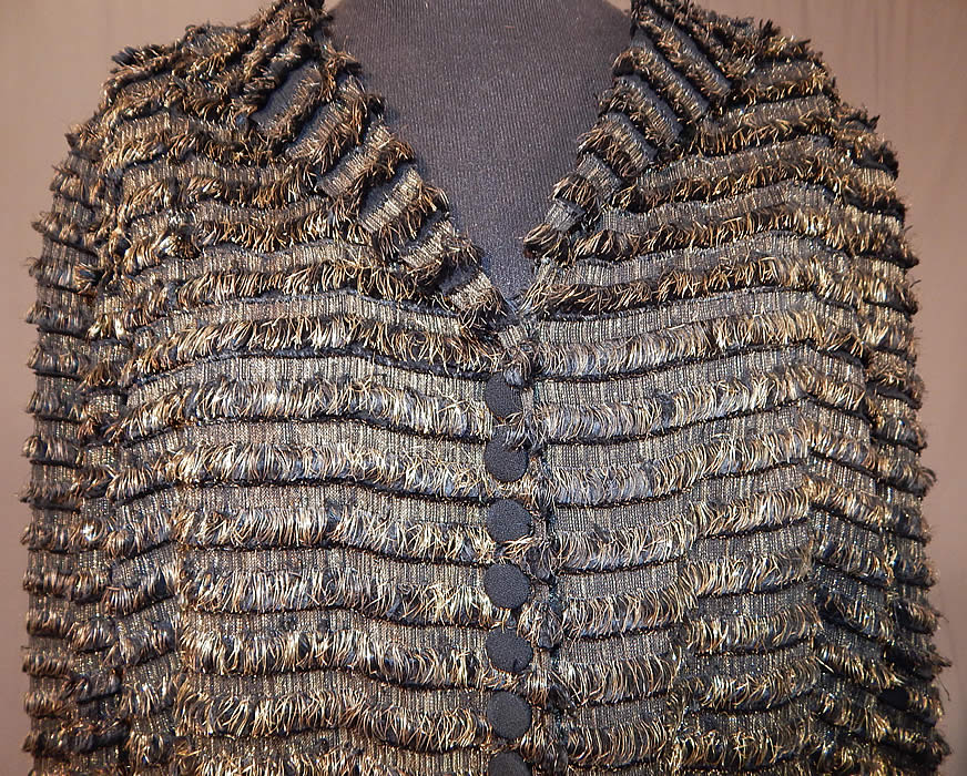 Vintage Art Deco Gold Lamé Lame Eyelash Fringe Peplum Evening Coat Jacket
This gorgeous gold evening jacket has a peplum skirted waist, with V front neckline, black silk covered decorative buttons down the front with hidden hook closures underneath, long sleeves and is lined. 