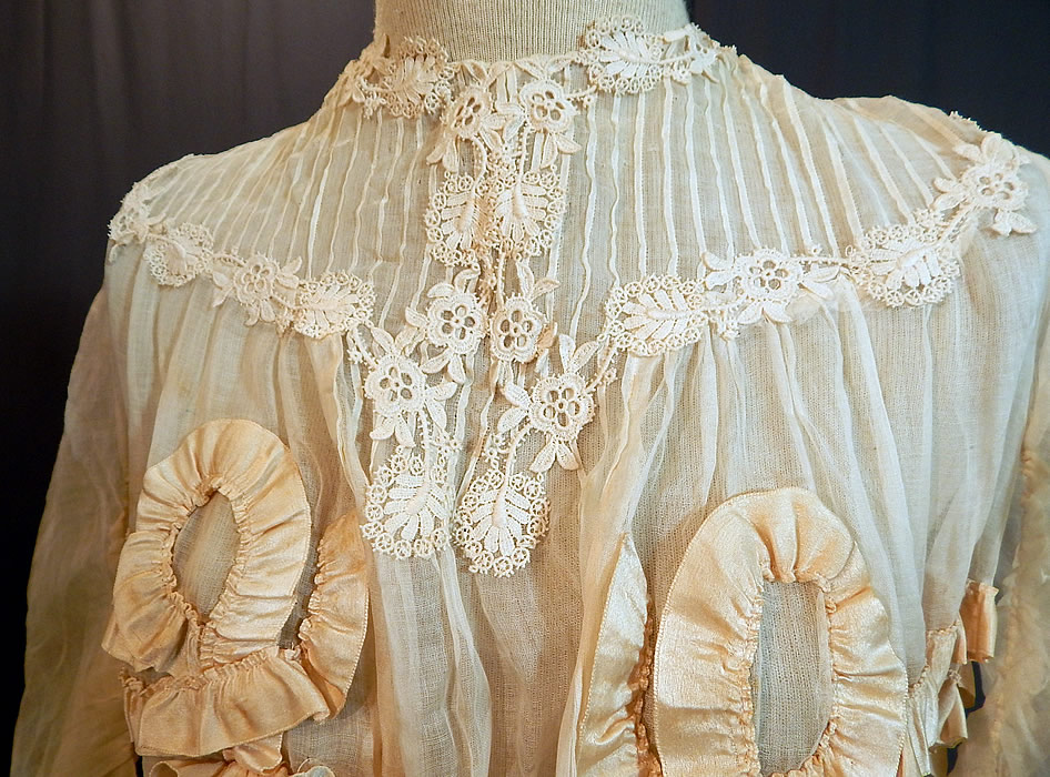 Edwardian White Cotton Muslin Lace Silk Ribbon Ruched Ruffle Trim Wedding Dress
This lovely lace long floor length dress has gathered shoulders with 3/4 length full tapered sleeves, a pouter pigeon front bodice, fitted waist, hook closures down the back and is sheer, totally unlined. 