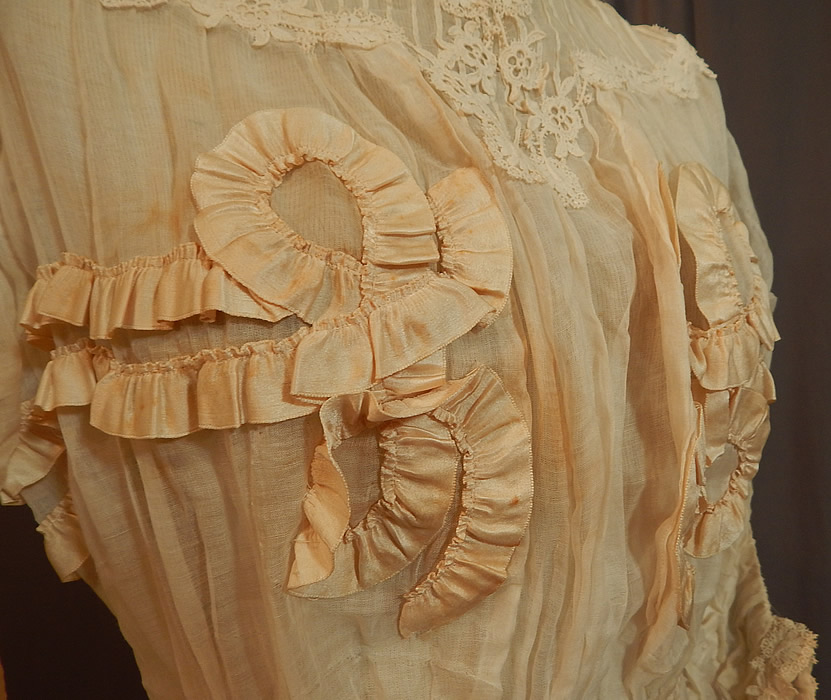 Edwardian White Cotton Muslin Lace Silk Ribbon Ruched Ruffle Trim Wedding Dress
It is in good condition, but has not been cleaned and has a few small faint stains on the front top, underarm and skirt. This is truly a wonderful piece of antique ribbon, lace textile art which could be worn as a wedding gown! 