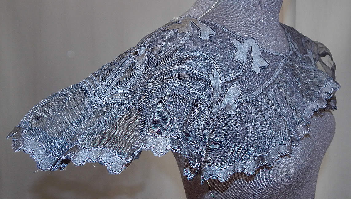 Vintage Black Silk Tulle Net Applique Shawl Collar Cape Capelet Dress Trim
This large shawl collar cape capelet dress trim has a ruffled bottom flounce, over the head style with no closure and is sheer, unlined. 