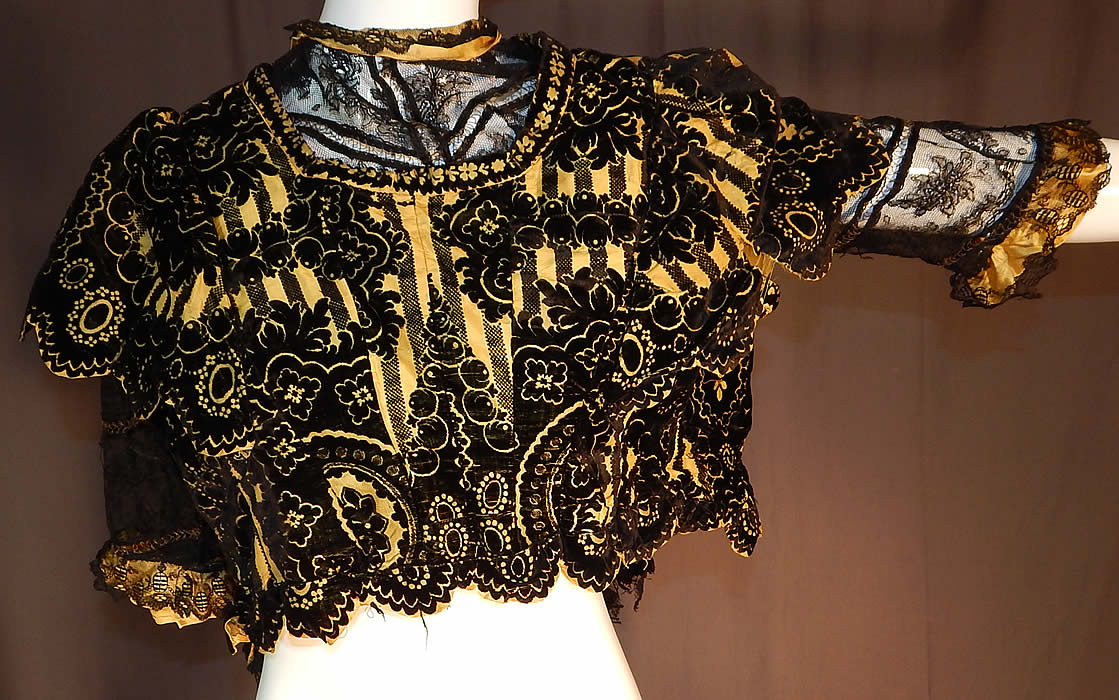 Victorian Yellow Silk Black Burnout Voided Velvet Devore Chantilly Lace Bodice
This antique Victorian era yellow silk black burnout voided velvet devore Chantilly lace bodice dates from 1880. 