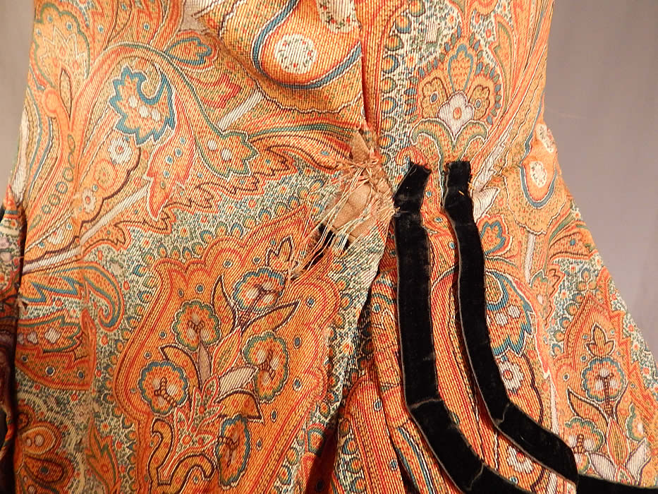 Victorian Civil War Era Paisley Wool Hoop Skirt Morning Wrapper Gown Dress
It is in fair as-is condition, missing the original buttons, has a small patched repair on the front top, some fraying around the neckline and several small frays in the fabric on the shoulder, back skirt, side pocket and underarm (see close-ups).