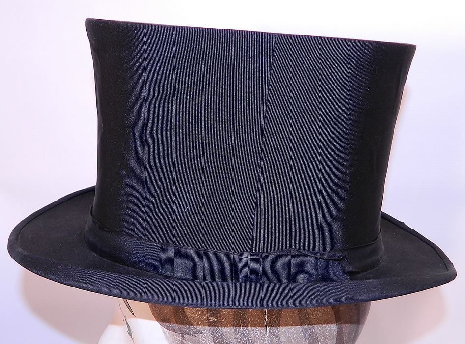 Vintage Kennedys Victorian Gentlemen Black Silk Collapsible Opera Top Hat. The hat measures 6 inches tall and 21 1/2 inches inside circumference.