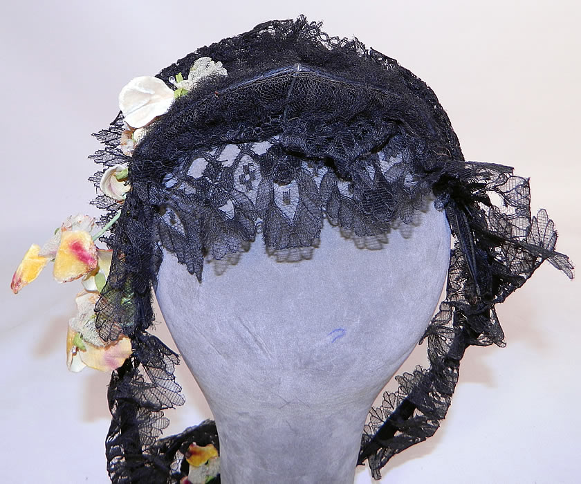 Victorian Civil War Era Black Chantilly Lace Floral Trim  Fanchon Bonnet Headdress. It is made of a headband style wired frame covered with a delicate fine sheer black chantilly lace with scalloped edging, black silk ribbon and yellow velvet pansy floral trim accents.