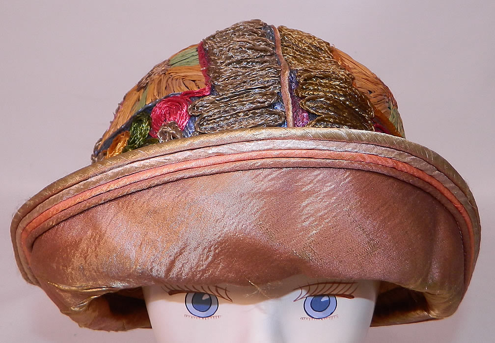 Vintage Colorful Straw Raffia Ribbon Work Embroidered Flapper Cloche Hat. It is made of a colorful straw and raffia done in a ribbon work embroidered technique covering the hat in a abstract geometric patchwork design. 