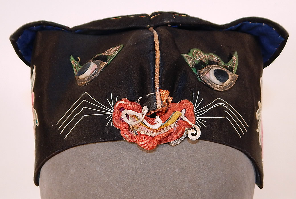 Antique Chinese Child Infant Silk Embroidered Applique Tiger Cat Wind Hat
This antique Chinese child infant silk embroidered appliqué tiger cat wind hat dates from the 1920s. It is hand stitched, made of black silk with colorful raised padded satin stitch embroidery work and an appliquéd tigers face on the front.
