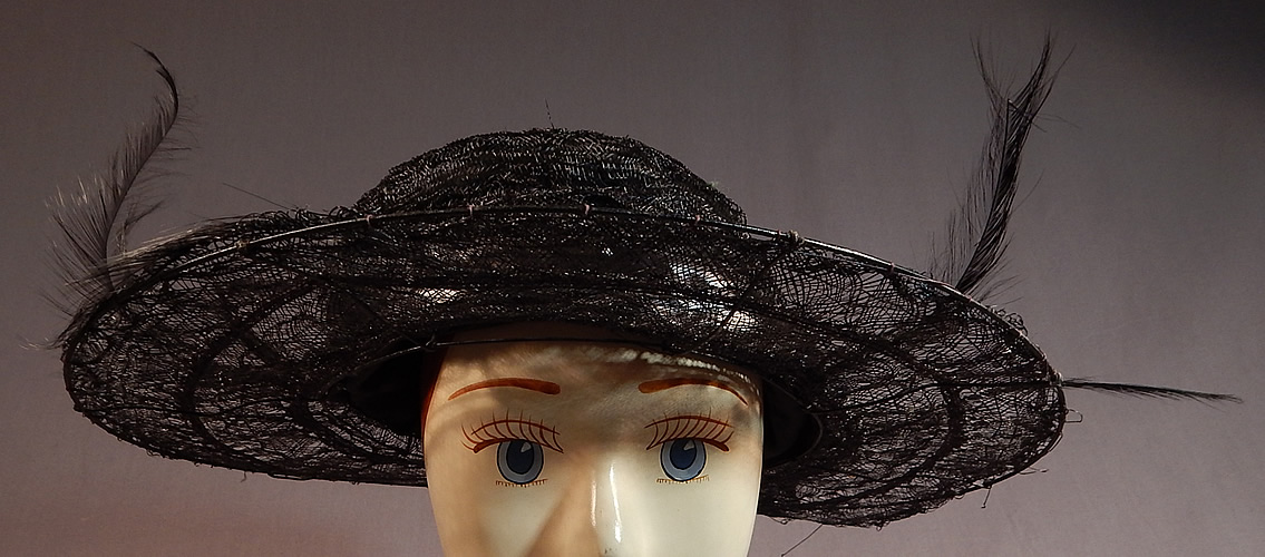 Edwardian Black Woven Horse Hair Crinoline Feather Trim Wired Wide Brim Hat
It is made of a black sheer woven stiffened horse hair crinoline covering a wired brim with black feather plume trim accents and a black silk lustrous ribbon hatband surrounding the crown.