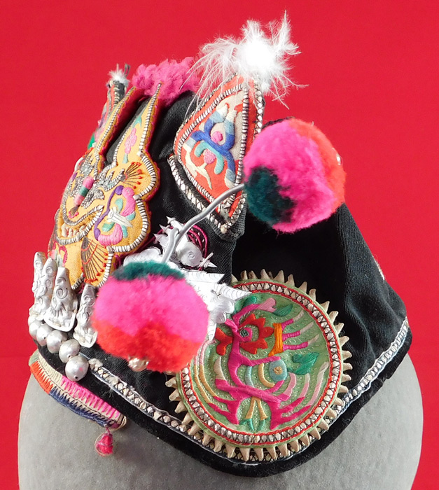 Antique Chinese Bai Miao Minority Childrens Festival Embroidered Tiger Wind Hat
These Bai Miao Minority Chinese children's ethnic hats were worn at festivals and designed to provide protection from evil spirits, demons, and ghosts, but also to influence the wearing with important qualities such as wealth, health, courage, academic success, happiness, long life, grace and beauty.
