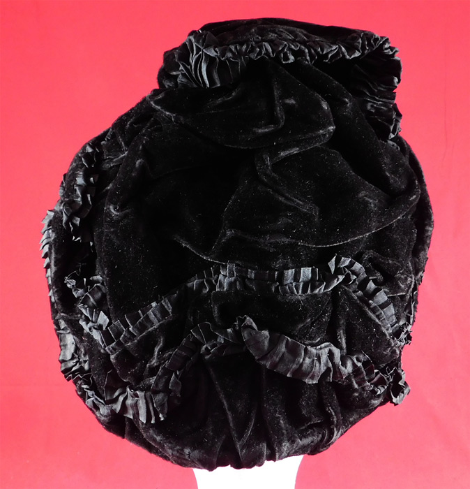 Victorian Black Velvet Silk Ruched Pleated Trim Mourning Bonnet Winter Hat
The bonnet measures 10 inches tall, 8 inches wide across, 4 inches deep and is 24 inches in circumference. 