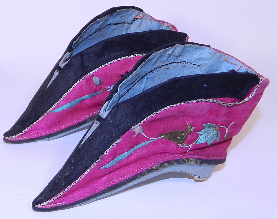Antique Chinese Silk Embroidered Mantis & Bird Bound Foot Lotus Slipper Shoes. This antique Chinese silk embroidered mantis and bird bound foot lotus slipper shoes date from the early 1900s. They are hand stitched and made of a purplish red pink fuchsia color silk fabric, with colorful raised padded satin stitch embroidery work of a phoenix bird on one side and a praying mantis insect on the other side.