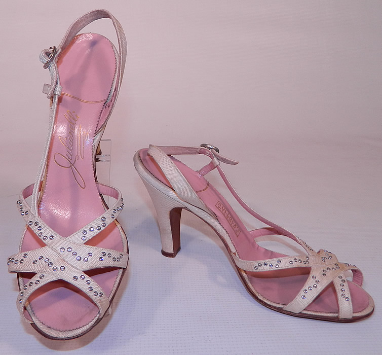 Vintage Julianelli White Linen Rhinestone Strap Sling Back Sandal Shoes. These stunning summer sandal style shoes have open toes, with crisscrossing straps on the vamps, an adjustable rhinestone buckle sling back strap and linen covered modified boulevard heel. 
