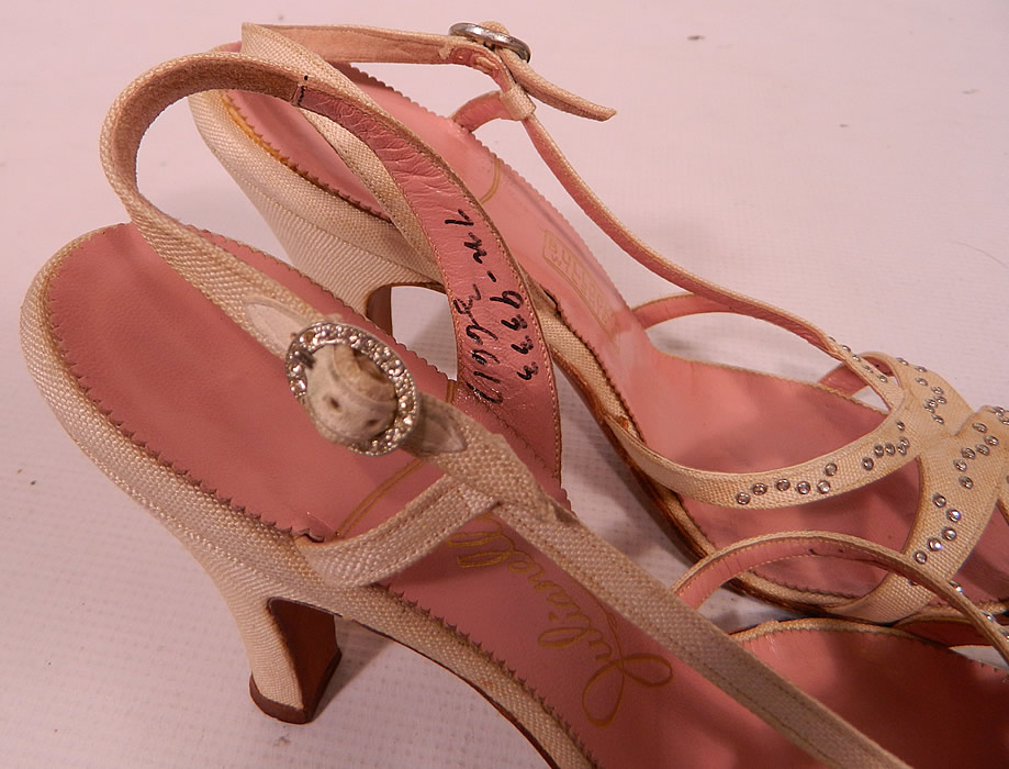 Vintage Julianelli White Linen Rhinestone Strap Sling Back Sandal Shoes. They have a pink insole lining with a gold embossed label inside "Julianelli", "Bullock's Wilshire" and are stamped a size 7 N. 
