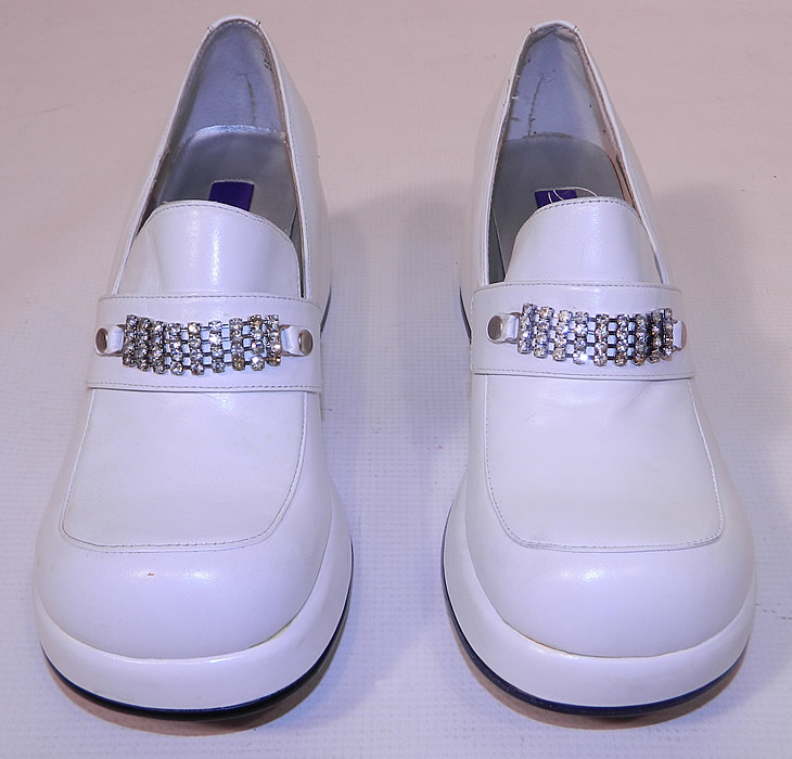 Unworn Vintage Baci Rhinestone Trim White Leather Loafers Disco Platform Shoes. They are made of a white leather with decorative rhinestone buckle strap trim across the insteps. 