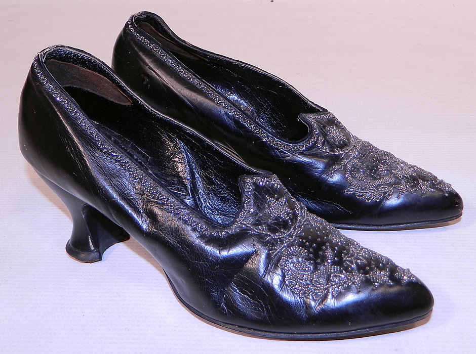 Victorian Black Leather Steel Cut Beaded Trim Patriotic Stars Shoes
This pair of antique Victorian era black leather silver steel cut beaded trim patriotic stars shoes date from 1900. They are made of black leather, with silver steel cut beading done in a patriotic star, shield, laurel wreath pattern design on the front toes and decorative beading going around the top sides.
