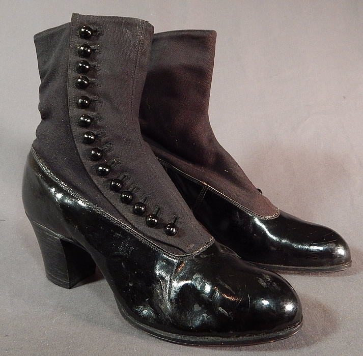 Victorian Unworn Womens Black Wool Patent Leather High Top Button Boots
This pair of antique Victorian era unworn womens black wool and patent leather high top button boots date from 1900. They are made of a black patent leather bottom shoe, with a black wool fabric top. 