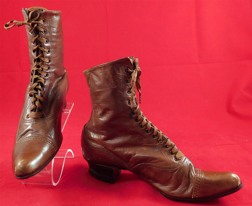 Victorian Antique Womens Brown Leather Laceup Boots Pointed Toe Shoes
This pair of antique Victorian era womens brown leather laceup boots pointed toe shoes date from 1880. They are made of a supple brown leather, with decorative scalloped stitched cutwork designs and punchwork across the toes. 