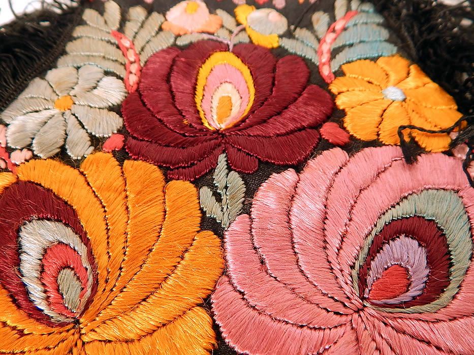 Vintage Matyo Hungarian Folk Embroidery Colorful Floral Fringe Boho Purse
There is a floral pattern design densely embroidered onto the fabric. This beautiful boho bag purse has a round pouch style, with black silk fringe trim edging, black rope carrying strap, is fully lined in linen and has an open top with no closure. 