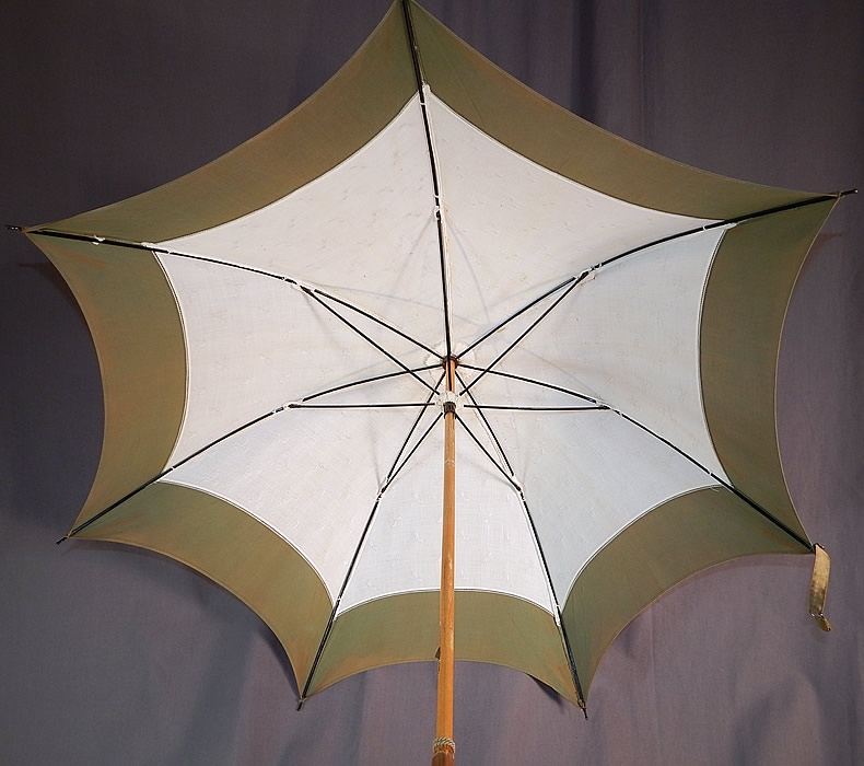Edwardian White Cotton Damask Bow Green Trim Wood Handle Summer Parasol
There is an oak wood handle stick, finial top with green gathered fabric trim. This summertime pretty parasol umbrella has a pagoda dome shape, with black metal frame inside, unlined, original button strap for keeping closed and green rope tassel trim hanging down the stick.