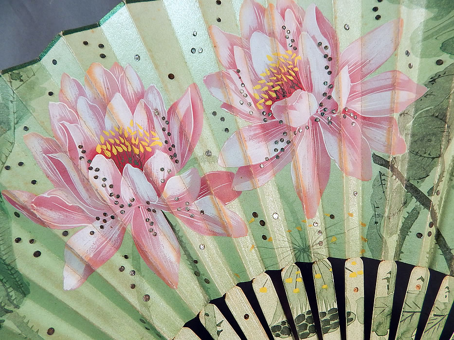 Art Nouveau Asian Hand Painted Paper Lotus Flower Sequin Pleated Folding Fan
It is made of a pleated opalescent white paper, with hand painted pink lotus flowers and celadon green thorny stems, leaves and an ombre hue background. 