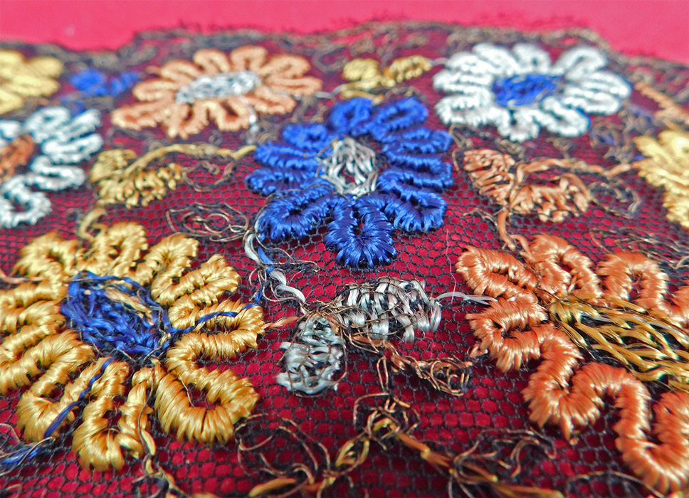 Vintage Art Deco Black Net Colorful Floral Daisy Embroidered Dress Trim Yardage
This vintage Art Deco black net colorful floral daisy embroidered dress trim dates from the 1920s. It is made of a sheer black net with colorful orange, yellow, blue and white silk thread embroidery work daisy flowers with gold metallic thread woven accents.