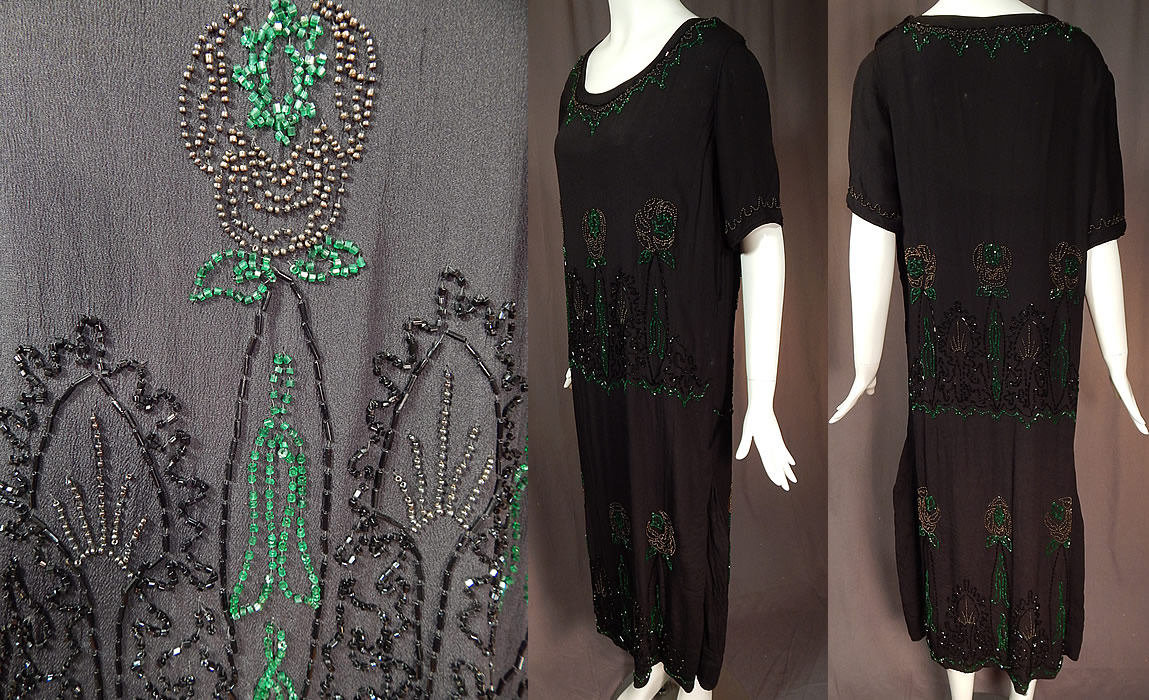 Vintage Art Deco Black Silk Crepe Emerald Green Beaded Floral Flapper Dress
This fabulous flapper dress has a loose fitting straight shift drop waist style, with short sleeves, a beaded rounded neckline, side and shoulder snap closures and is lined only in the top with a black silk camisole sewn inside. 