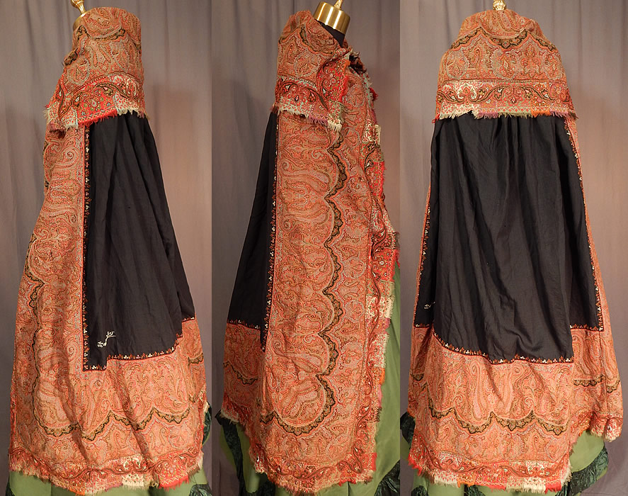 Victorian Antique Wool Signed Kashmir Paisley Shawl Collar Cloak Cape
This Victorian era antique wool signed Kashmir paisley shawl collar cloak cape dates from the 19th century. It is made of jacquard hand loomed woven wool done in strong bright vivid autumn fall colors, with the black wool center pieced on the back and signed by the weaver in a white hand embroidered stitching and a colorful floral leaf border edging the black square center. 