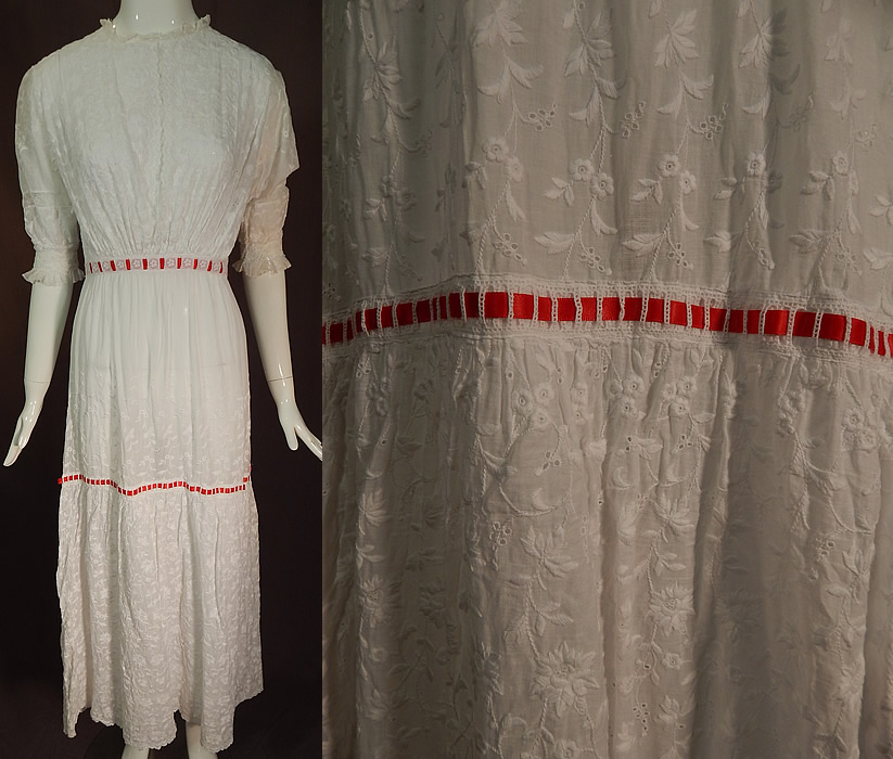 Edwardian White Cotton Batiste Floral Eyelet Embroidered Lace Lawn Dress Tea Gown
This vintage Edwardian era white cotton batiste floral eyelet embroidered lace lawn dress tea gown dates from 1910. It is made of a white cotton batiste lawn fabric, with a white raised padded satin stitch hand embroidery work whitework densely done in floral vine leaf design and eyelet drawn cutwork accents.