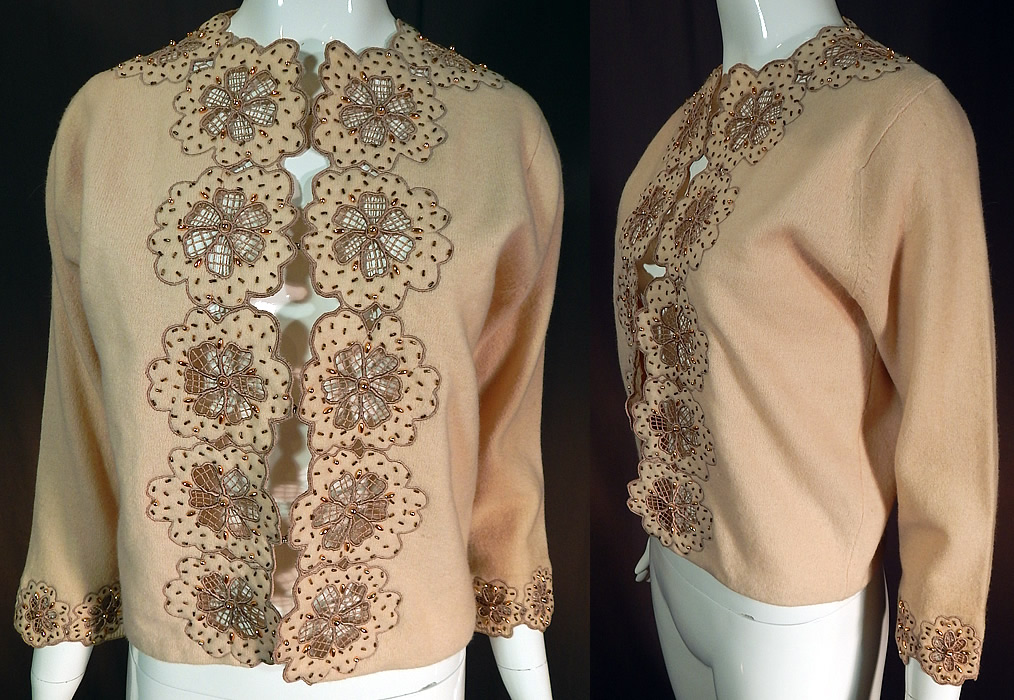 Vintage Vic & Vic Haute Couture Hong Kong Beaded Cutwork Cardigan Sweater
This vintage Vic & Vic Haute Couture Hong Kong beaded cutwork cardigan sweater dates from the 1960s. It is made of an ecru beige color lambswoo fabric, with embroidered outlined cutwork flowers and gold beaded accents.