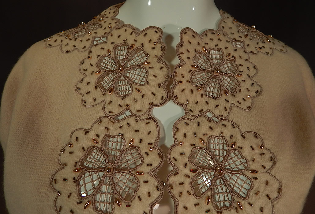 Vintage Vic & Vic Haute Couture Hong Kong Beaded Cutwork Cardigan Sweater
This lovely lacy cardigan sweater has sheer floral cutwork lace flowers trimming the front opening, neckline, cuffs, long full sleeves, fully lined and hook closures down the front.