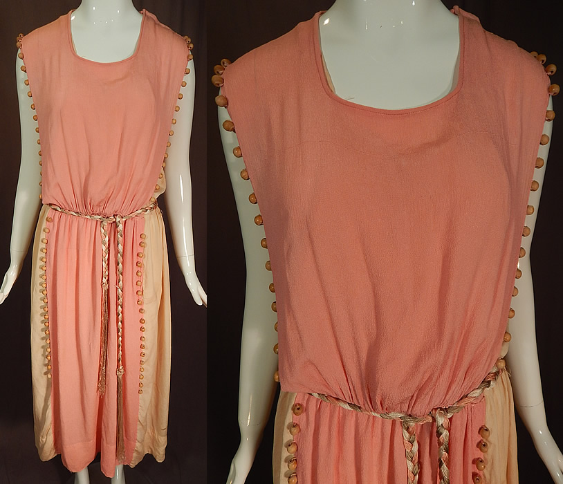 Vintage Grecian Goddess Pink Silk Crepe Wood Beaded Belted Tabard Tunic Dress
This vintage Grecian goddess pink silk crepe wood beaded belted tabard tunic dress dates from the 1920s. It is made of a pink silk crepe de chine fabric with a natural polished wood beading trim along the side edging and a pale pink blush color silk crepe de chine lining.