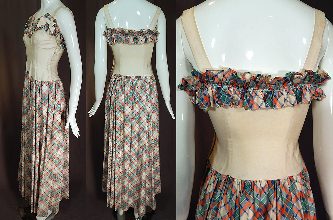 Vintage White Cotton Pastel Plaid Print Ruffle Flounce Bow Trim Maxi Dress
This stunning sundress long floor length maxi dress has a ruffle flounce trim sweetheart neckline, with white bow trim shoulder straps, a fitted bodice, long full plaid skirt, side hook closures and is unlined.