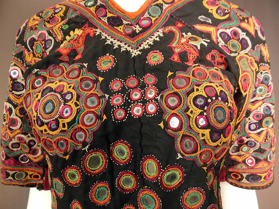 Vintage Indian Gujarati Kutch Work Embroidered Mirror Choli Boho Blouse Top
This stunning traditional handmade hand embroidered fitted, short cropped choli boho blouse top has an open back with two adjustable back tie strap closures at the neck, waist and is fully lined in a green and yellow floral print cotton fabric inside. The top measures 19 inches long, with a 34 inch bust and 26 inch waist.
