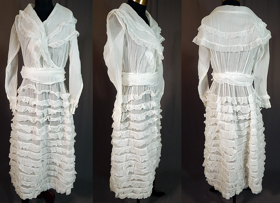 Edwardian White Cotton Organdy Ruffled Fichu Belted Dress Tea Gown
This vintage Edwardian era white cotton organdy ruffled fichu belted dress tea gown dates from 1915. It is made of a sheer white cotton organdy fabric with layered rows of ruffles on the skirt. 