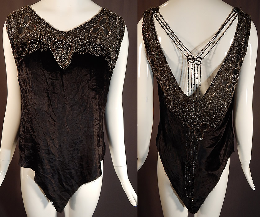Vintage Art Deco Black Velvet Silver Studded Beaded Fringe Flapper Blouse Top
It is made of a black silk velvet fabric, with steel gray, crystal and silver metal studs beadwork done in an abstract scrolling spiral floral leaf design along the yoke neckline backed on a black sheer silk chiffon fabric and beaded fringe hanging down the back.