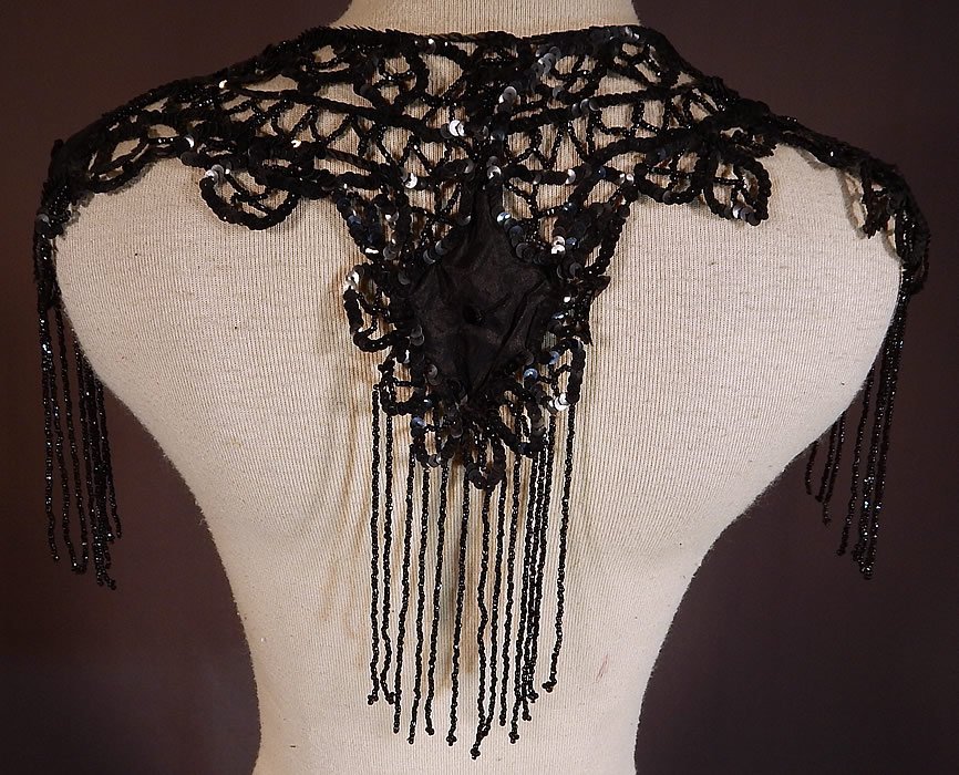 Victorian Black Silk Sequin Jet Beaded Fringe Shawl Collar Dress Trim
This beautiful beaded shawl collar dress trim has an ornamental shoulder epaulette style, with scalloped edging and is sheer, unlined. The collar measures 10 inches long with fringe and is 30 inches wide. 