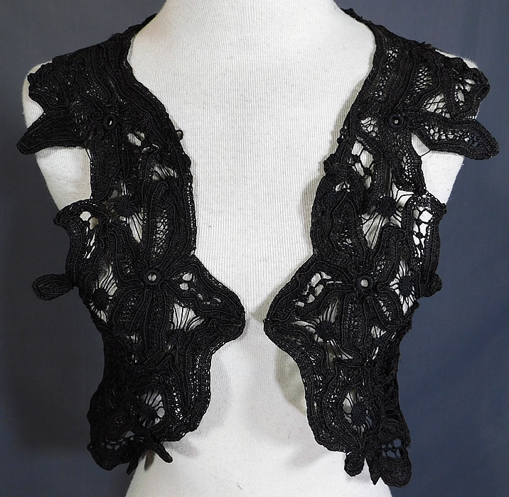 Victorian Antique Black Battenburg Lace Short Sleeveless Vest Crop Bolero Jacket
This lovely lace sleeveless vest style short crop top shrug bolero jacket has a cut away scalloped open front with no closure and is sheer, unlined.