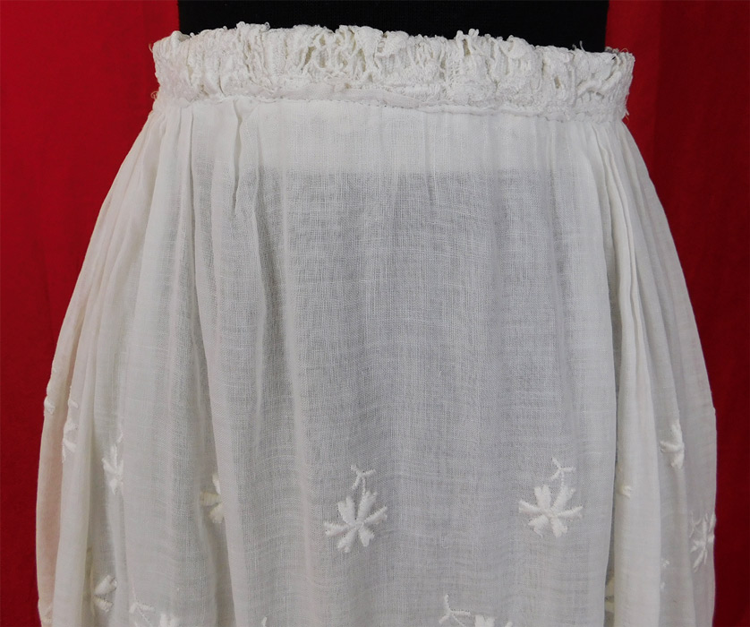 Edwardian Embroidered White Cotton Batiste Lace Layered Tea Length Skirt
This vintage Titanic Edwardian era embroidered white cotton batiste lace layered tea length skirt dates from 1912. It is made of a sheer white cotton batiste fabric with white raised padded satin stitch embroidery work flower, leaf designs and floral pattern lace.