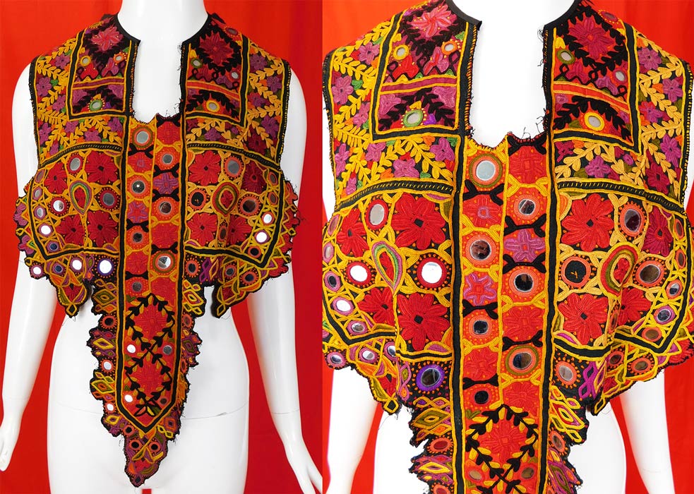 Vintage Indian Gujarati Kutch Work Ethnic Embroidered Mirror Boho Bib Top
This vintage antique Indian Gujarati kutch work ethnic embroidered mirror boho bib top dates from the 1920s. It is made of a linen fabric covered with vibrant colorful decorative kutch work embroidery done in the tribal folk patterns from Gujarati, Rajasthan India and Sindh Pakistan. 