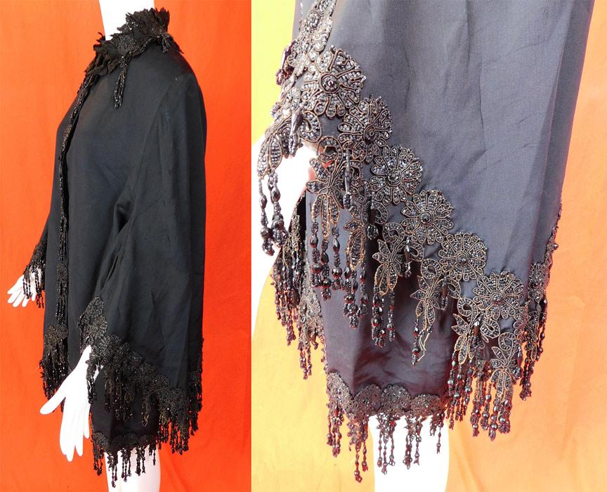Victorian Black Silk Jet Beaded Fringe Tassel Trim Dolman Mantle Cloak Cape
This antique Victorian era black silk jet beaded fringe tassel trim dolman mantle cloak cape dates from 1880. It is made of a heavy black silk grosgrain taffeta fabric, with black jet beaded applique floral fringe tassel trim along the bottom edging, collar, cuffs and front opening.